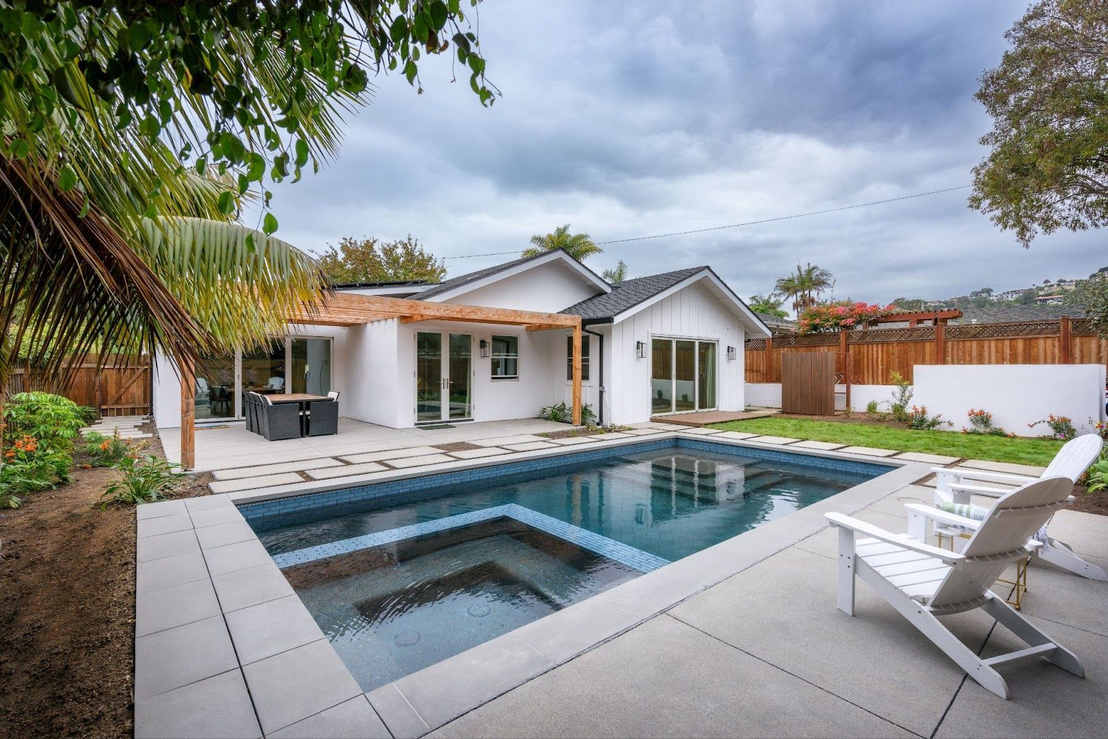 Fluidity pool design with spa and modern backyard patio